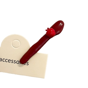Dark red apple hair clip with glossy finish on white card for women hair styling