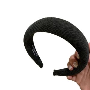 Thick knitted headband in charcoal grey featuring a puffy sponge padded silhouette