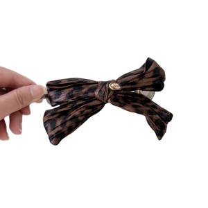 Leopard print bow hair clip with gold metal love charm for elegant styling