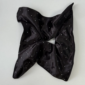 Detailed view of black satin hair scrunchie with shimmering silver rhinestones detail