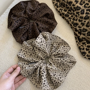 Fashionable leopard print oversized scrunchies in brown and beige silk fabric