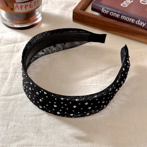 Detailed shot of black mesh headband with sparkling rhinestones and non-slip inner teeth