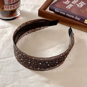 Close-up of brown mesh headband with sparkling silver rhinestones and non-slip inner teeth