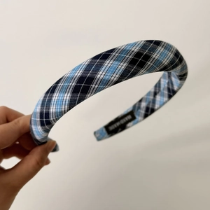 Detail of blue plaid fabric headband with handmade label and non-slip inner texture