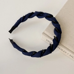 Detailed view of navy blue fabric braided headband with integrated hair fixing clips