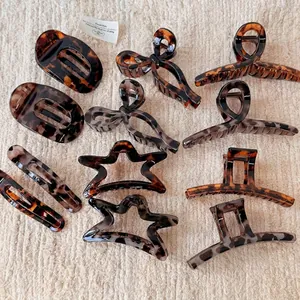 Retro leopard print acetate hair claws in various geometric shapes on waffle fabric