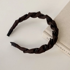 Close-up of woven satin headband in dark coffee with mini hair clips for secure styling