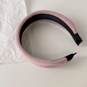 Close-up of pink plush hair scrunchie showing faux mink fur texture and soft fabric