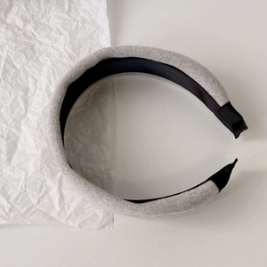 Close-up of thick plush velvet headband with soft grey fabric and black lining detail