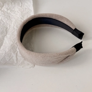 Close-up of soft plush hairband with sponge padding and non-slip black lining fabric