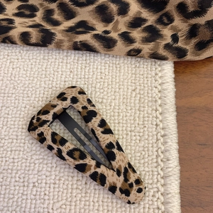 Detailed macro view of leopard print fabric BB hair clip with retro Y2K style design