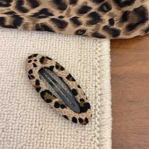 Detailed view of leopard print fabric BB hair clip with retro Y2K pattern design