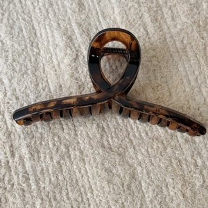 Macro detail of large tortoise shell hair claw clip with vintage amber leopard pattern