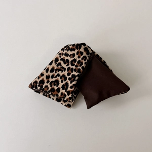 Detail view of the leopard print and coffee brown fabric textures on large hair scrunchies