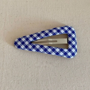 Close-up of blue and white checkered fabric BB hair clip with silver metal interior