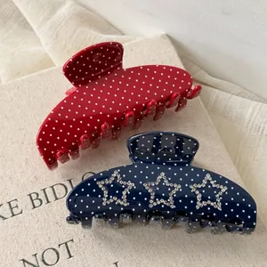 Polka dot hair claw clips with rhinestone star design in red and navy blue acetate