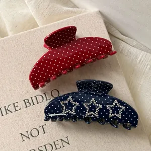 Polka dot hair claw clips with rhinestone star charms in red and navy blue finish