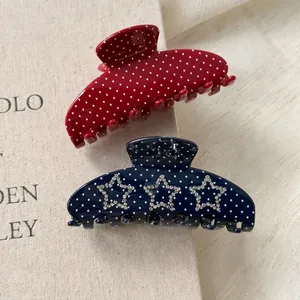 Polka dot acetate shark hair claws with rhinestone stars in red and navy blue
