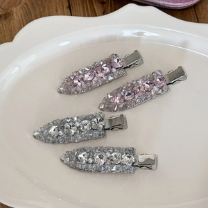 Elegant rhinestone hair clip set in pink and silver on a white ceramic tray for women