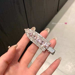 Detail of glittery silver hairpin with pink water-drop crystals and white pearls