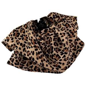 Elegant leopard print fabric claw clip with fluffy design on a clean white background
