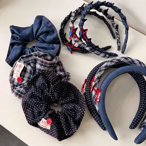 Dark blue plaid headband set with red bow accents and dental slip-proof design