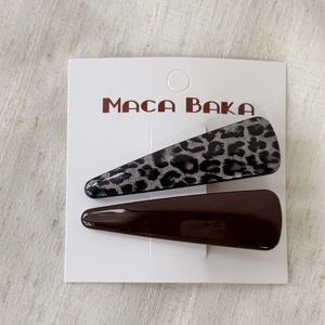 Detail of leopard print and solid brown hair clips set on display card in macro view