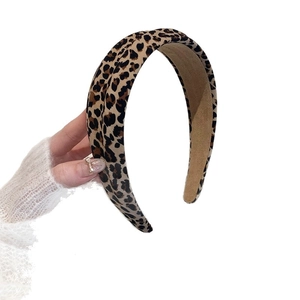 Handheld view of wide leopard print headband with thick fabric and non-slip lining