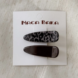 Close-up of leopard print and dark brown hair clip set on a white display card