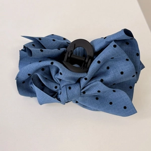 Detail view of blue polka dot bow hair claw clip with strong spring clasp mechanism