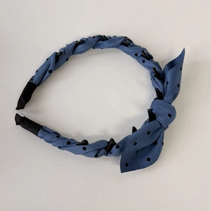 Detailed macro view of the non-slip hair comb teeth and blue polka dot fabric texture