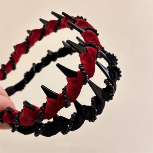 Gothic style velvet headband with red and black wrap design and punk spike studs