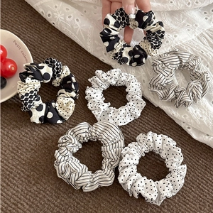 Polka dot and striped fabric scrunchie set in black and white minimalist style