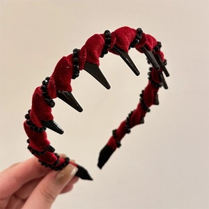 Close-up of red velvet headband with black bead trim and anti-slip comb teeth