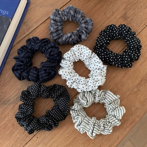 Set of six Korean style fabric scrunchies with polka dots and stripes on wood surface