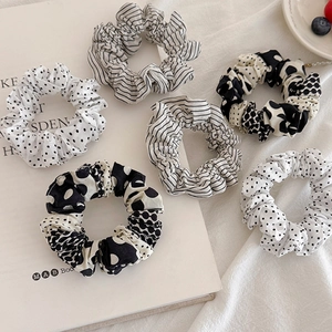 6-piece set of black and white polka dot and striped fabric scrunchies on white background