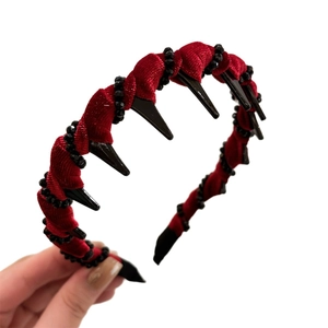 Gothic red velvet headband with black spikes and beaded trim for a high-volume hair look