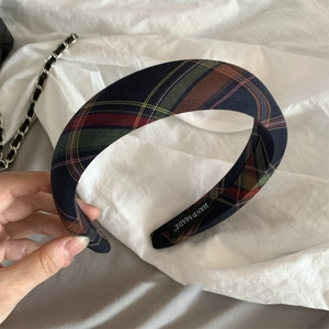 British style plaid sponge headband with handmade label on white fabric background