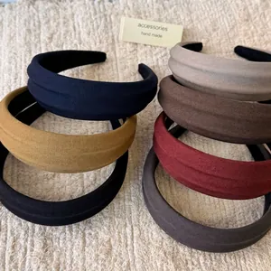 Chic retro padded headband in seven colors made of twill cotton fabric on plush background