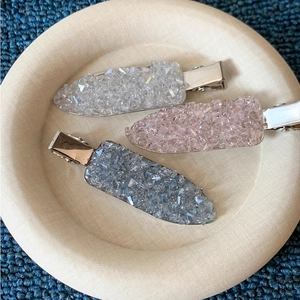 Elegant rhinestone hair clips in white, pink and blue set on a metallic base