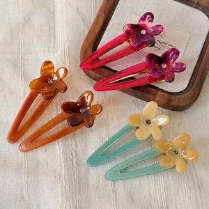 Plumeria acetate flower hair clips set with rhinestone accents and hollow duckbill base