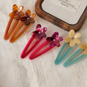 Colorful acetate frangipani flower hair clips with crystal accents in a six-piece set