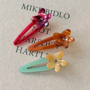 Three-piece colorful acetate frangipani flower hair clips with sparkling rhinestone centers