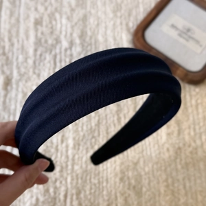Detailed close-up of dark blue ribbed texture headband with smooth black non-slip lining