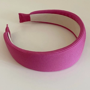 Close-up of rose pink ribbed fabric headband showing thick sponge texture and neat lining