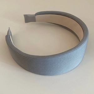 Detail view showing light blue ribbed knit texture and sponge padded headband design