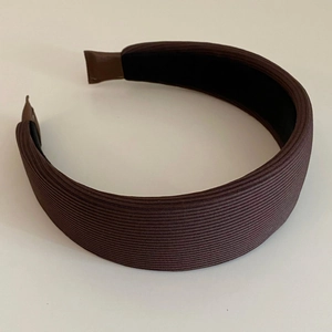 Detail view of coffee brown ribbed knit sponge headband with black non-slip inner lining