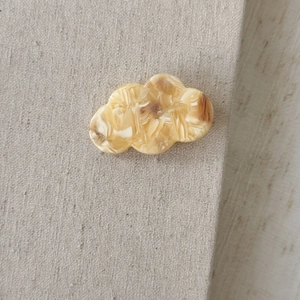 Detail of cream marble acetate cloud hair clip with France Handmade engraving