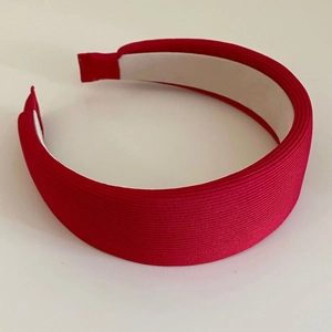 Close-up of red ribbed fabric headband featuring a non-slip lining and wide padded design