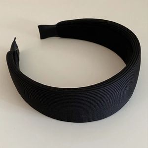 Detail view of the ribbed fabric texture and protected ends on this black headband